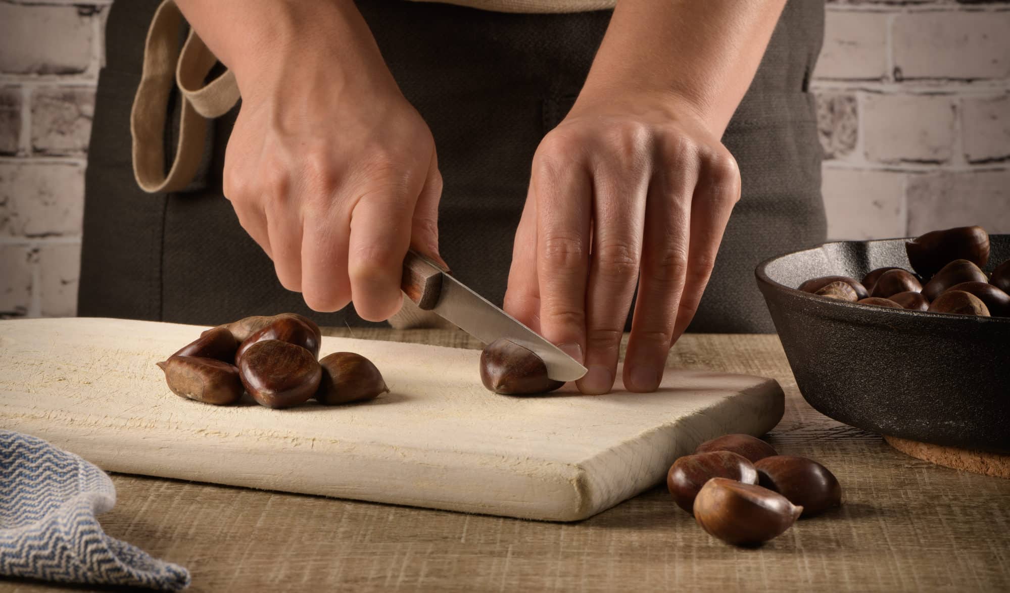 Woman cuts chestnuts
